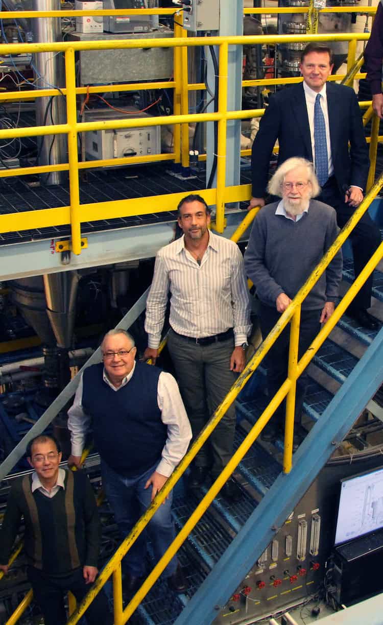 Highbury management team standing on industrial staircase.